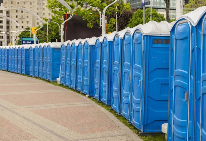 a line of portable restrooms at an outdoor wedding, catering to guests with style and comfort in Alva